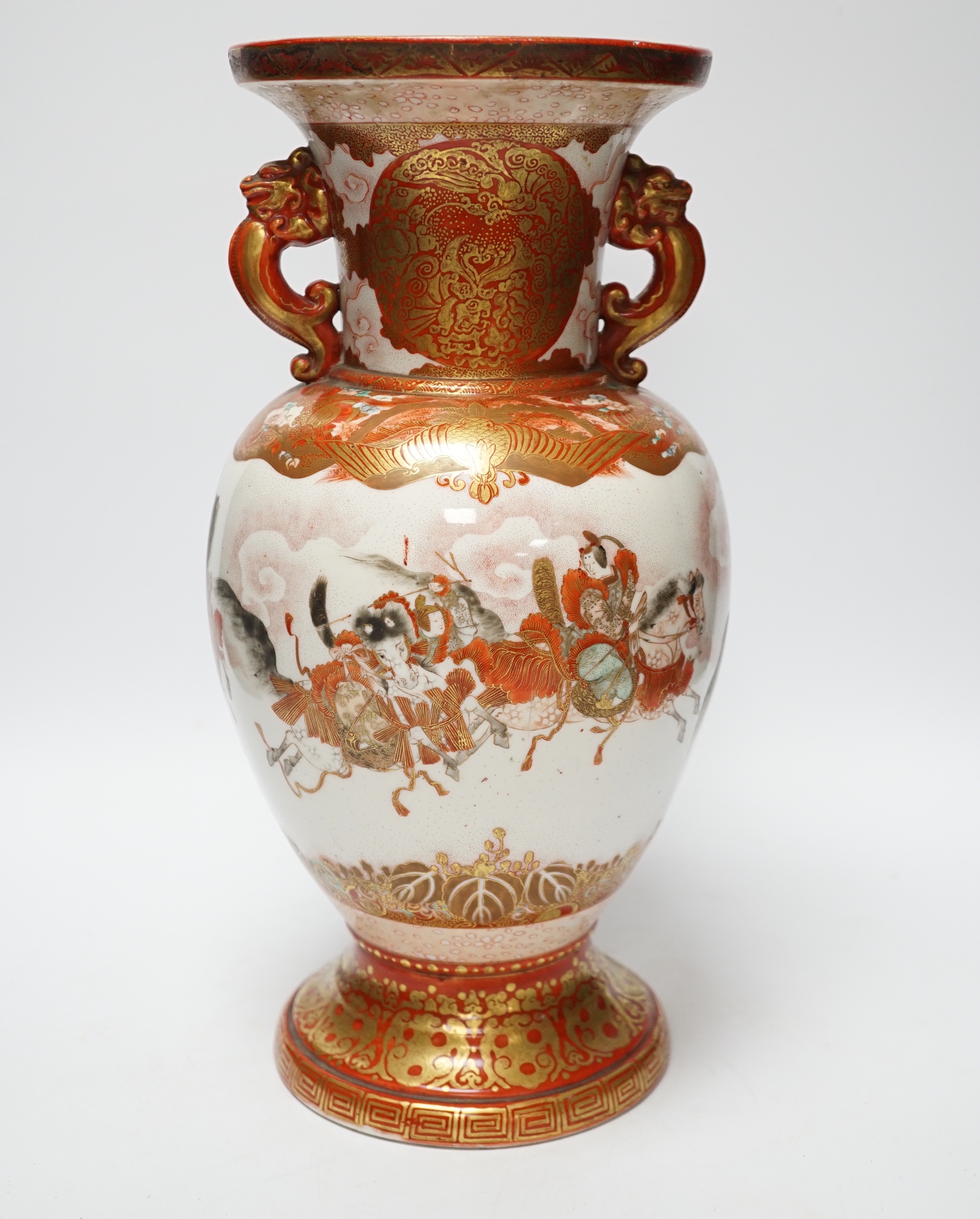 A Japanese Kutani porcelain twin handled vase, Meiji period, decorated with warriors on horseback, 34.5cm high